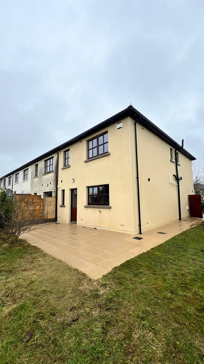 The same home after softwashing — render and surfaces restored