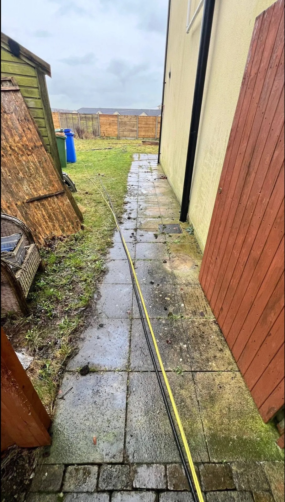 A County Meath patio before cleaning — moss, algae and black streaks across the slabs